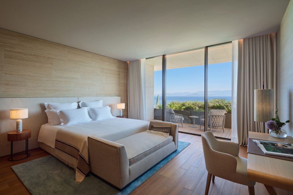 Interior of Bulgari Bodrum's Primary Bedroom with a light color scheme and wooden wall that has direct access to outdoor patio.